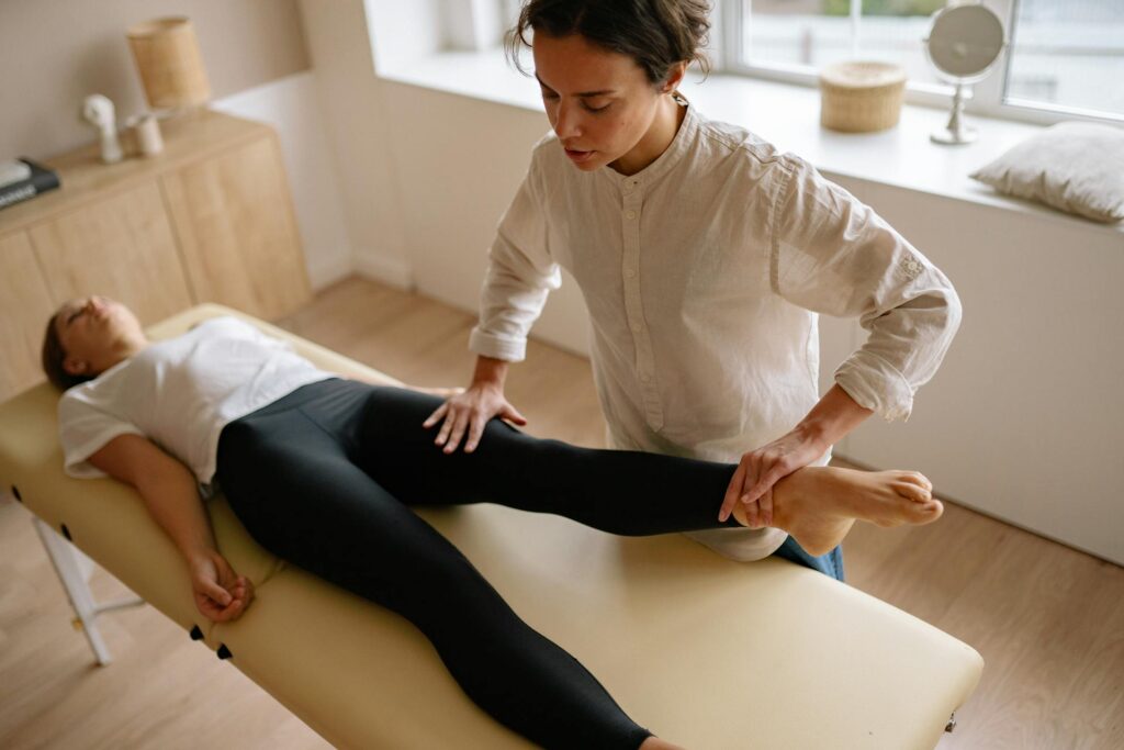 Chiropractor Holding Woman's Leg