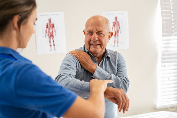 A physiotherapist assisting a senior patient with joint pain exercises in Newmarket clinic