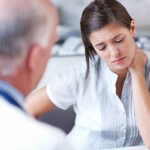 Chiropractor explaining spinal alignment to Newmarket patient