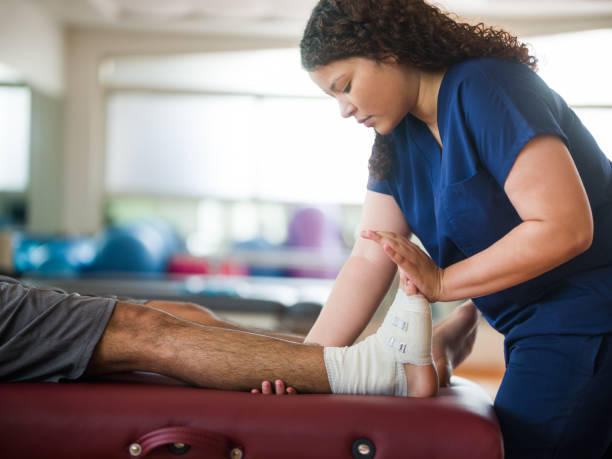 Chiropractor in Newmarket adjusting patient's ankle for pain relief