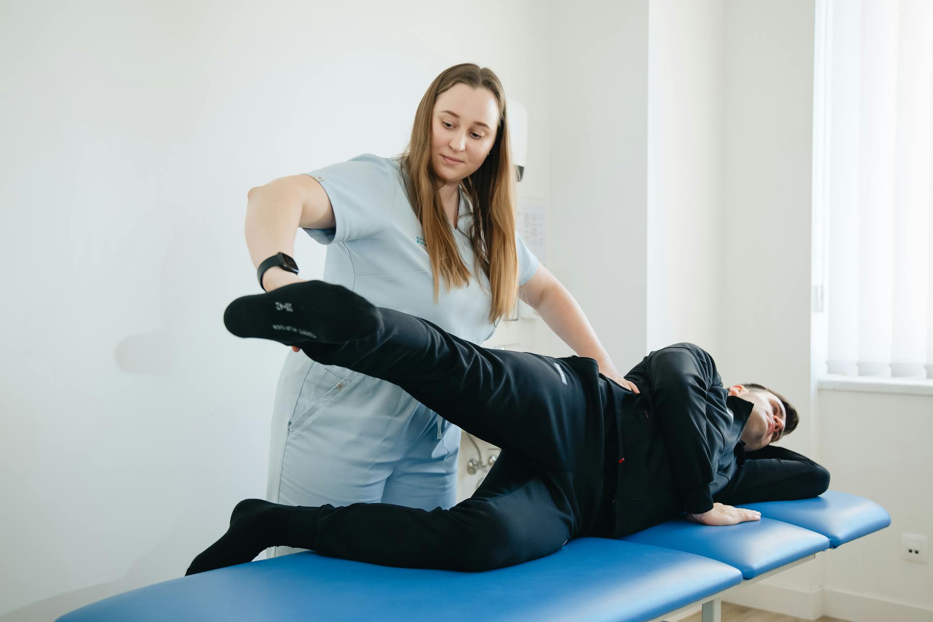 Chiropractor performing adjustment on athlete in Newmarket sports clinic