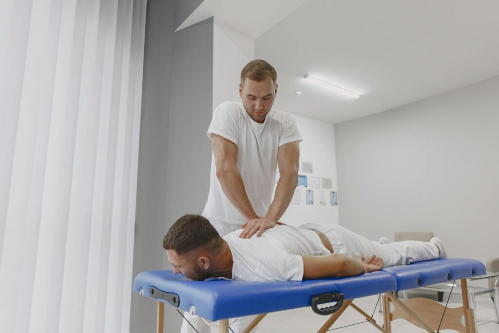 Massage therapist in Newmarket applying deep tissue massage to relieve muscle tension from sports injury