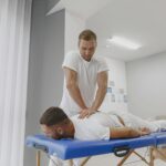 Massage therapist in Newmarket applying deep tissue massage to relieve muscle tension from sports injury