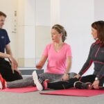 Office workers stretching guided by a physiotherapist in Newmarket