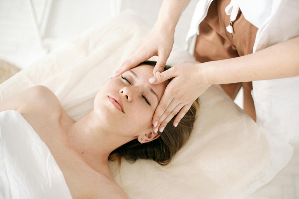 Pregnant woman receiving gentle prenatal massage in Newmarket clinic