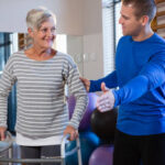 Senior patient working on balance exercises with physiotherapist at Newmarket clinic