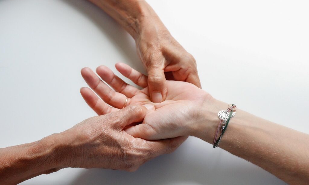 A licensed massage therapist providing wrist pain relief treatment at a Vaughan wellness