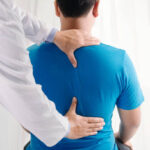 Chiropractor in Vaughan performing spinal adjustment on patient at PhysioChiroWellness clinic