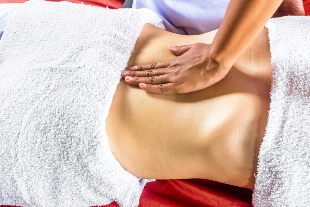 Massage therapist in Newmarket performing abdominal massage for digestive relief