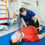 Physiotherapist applying manual therapy to patient’s shoulder in Newmarket clinic