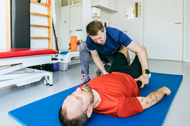 Physiotherapist applying manual therapy to patient’s shoulder in Newmarket clinic