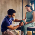 Physiotherapist helping a patient with knee strengthening exercises at a Vaughan clinic