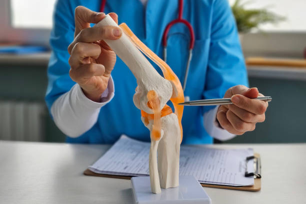 Physiotherapist in Newmarket assisting ACL recovery exercises with patient
