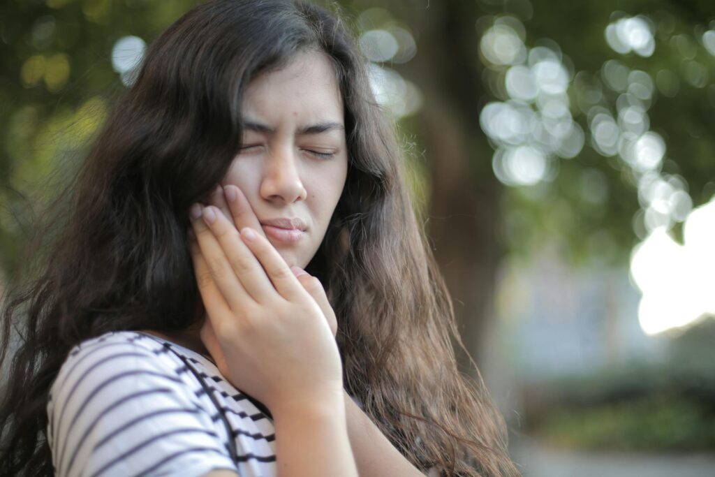 Physiotherapist performing TMJ treatment on patient’s jaw at Newmarket clinic