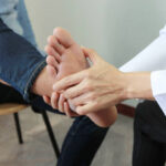 Physiotherapist treating a patient’s ankle injury during physiotherapy session in Vaughan clinic