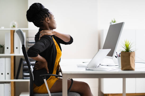 Professional chiropractor in Newmarket adjusting a patient's posture at an ergonomic workstation