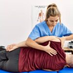 Professional chiropractor in Newmarket adjusting athlete's spine during sports performance treatment