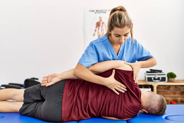 Professional chiropractor in Newmarket adjusting athlete's spine during sports performance treatment
