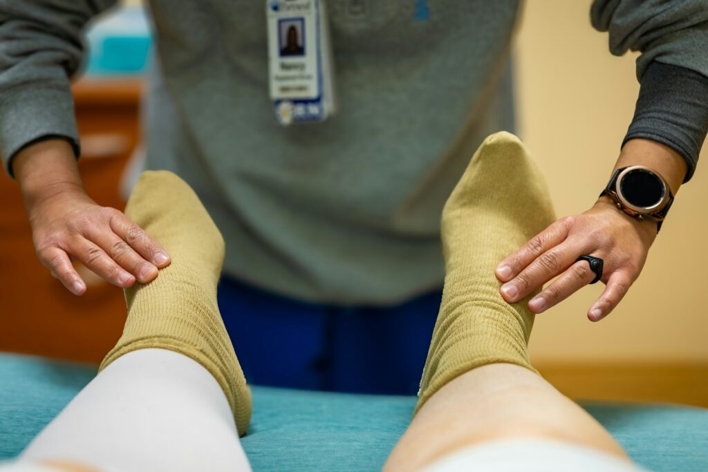 A massage therapist working on a client’s injured ankle at PhysioChiroWellness clinic in Newmarket