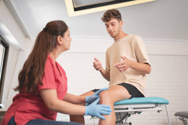 A physiotherapist assessing a runner's knee pain at PhysioChiroWellness in Newmarket A physiotherapist assessing a runner's knee pain at PhysioChiroWellness in Newmarket