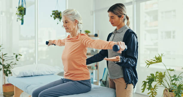 A physiotherapist in Newmarket guiding a patient through gentle stretching exercises during a rehabilitation session.