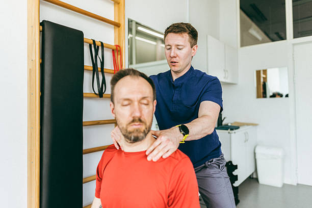 A physiotherapist in Newmarket performing manual therapy on a patient's neck