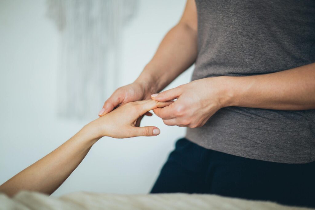 Chiropractor in Newmarket gently adjusting a patient’s wrist to relieve hand pain