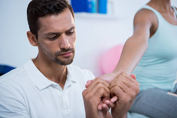 Chiropractor in Newmarket performing wrist mobilization and soft tissue therapy for wrist pain