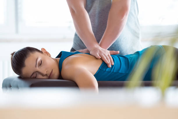 Chiropractor performing gentle spinal adjustment in Newmarket clinic