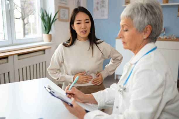 Naturopath in Newmarket reviewing gut health symptoms with a patient at PhysioChiroWellness clinic