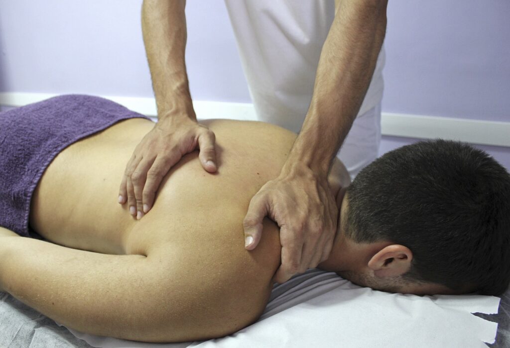 Massage therapist in Newmarket providing pain relief treatment to a patient