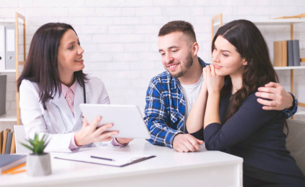 A naturopathic doctor discussing fertility test results with a couple in Vaughan clinic