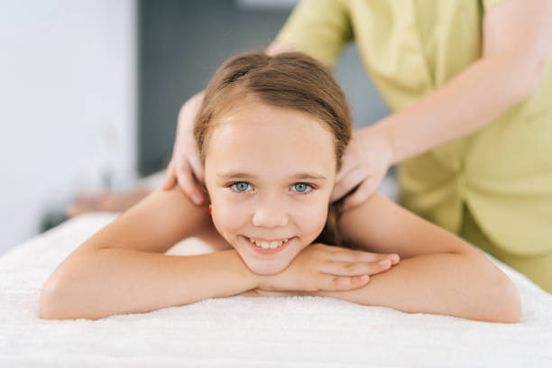Child receiving massage therapy in Newmarket to support growth, relaxation, and stress relief