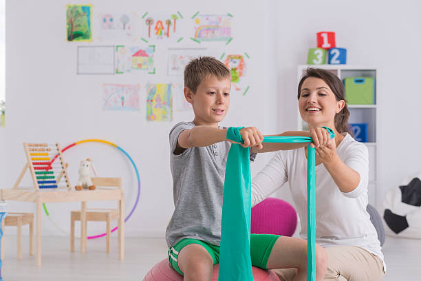 Child stretching during a fun pediatric physiotherapy session in Newmarket clinic