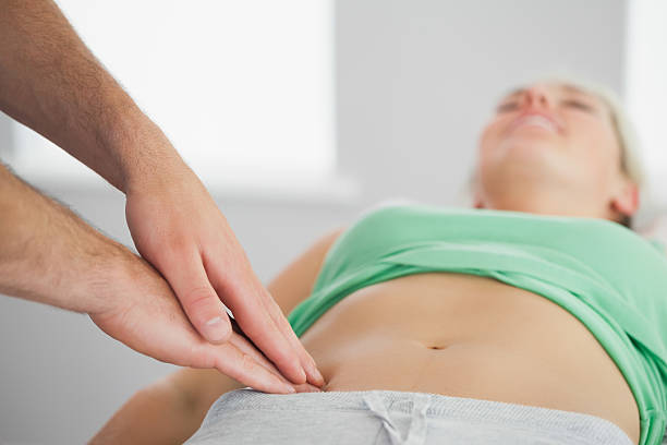 Chiropractor adjusting a new mother for postpartum back pain relief in Newmarket