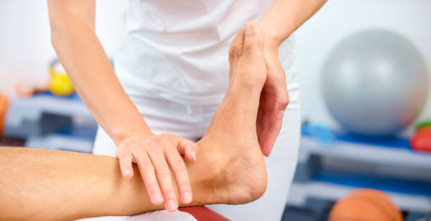 Chiropractor in Vaughan gently examining a patient’s injured ankle