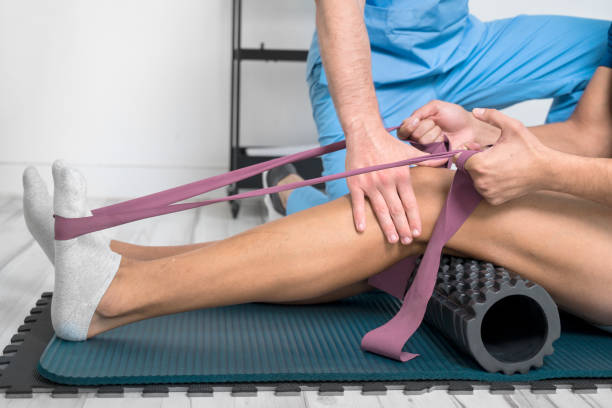 Physiotherapist helping patient exercise after knee surgery in Newmarket