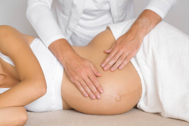 Pregnant woman receiving gentle prenatal massage therapy in Newmarket