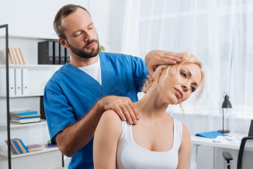 A chiropractor-in-Newmarket-stretching-neck-of-woman-during-appointment