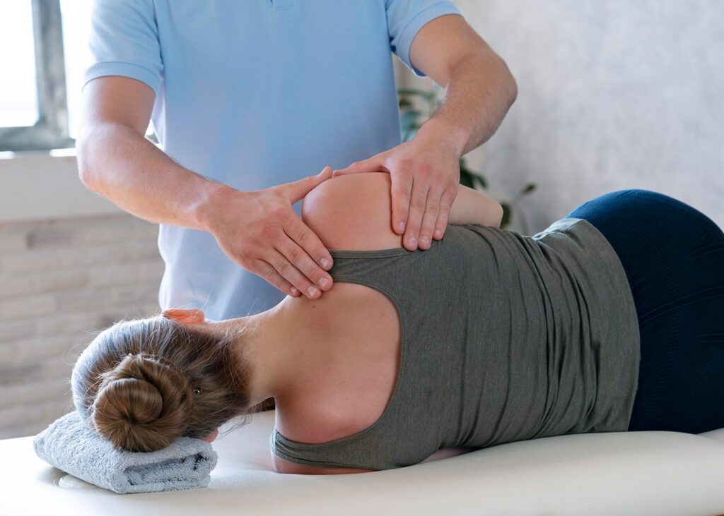 Chiropractor in Newmarket adjusting a patients spine image-2