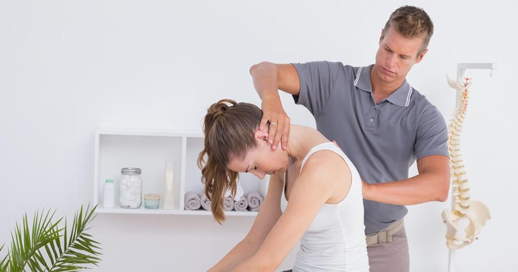 Chiropractor performing spinal adjustment at PhysioChiroWellness clinic in Newmarket