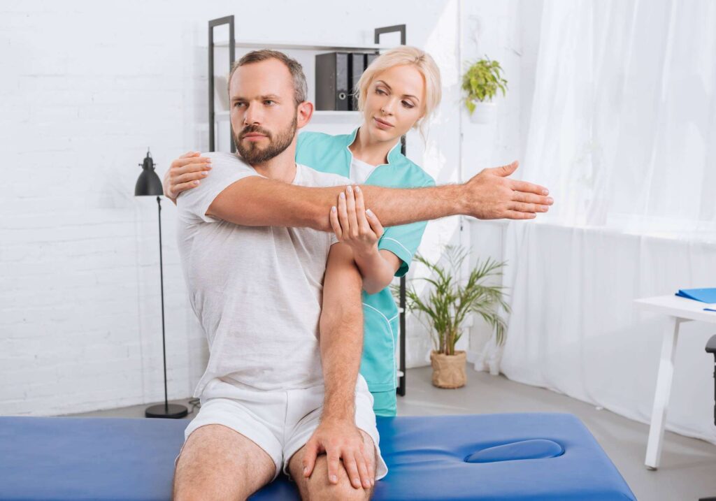 Physiotherapist in Newmarket providing personalized treatment to a patient at PhysioChiroWellness Clinic physiotherapy