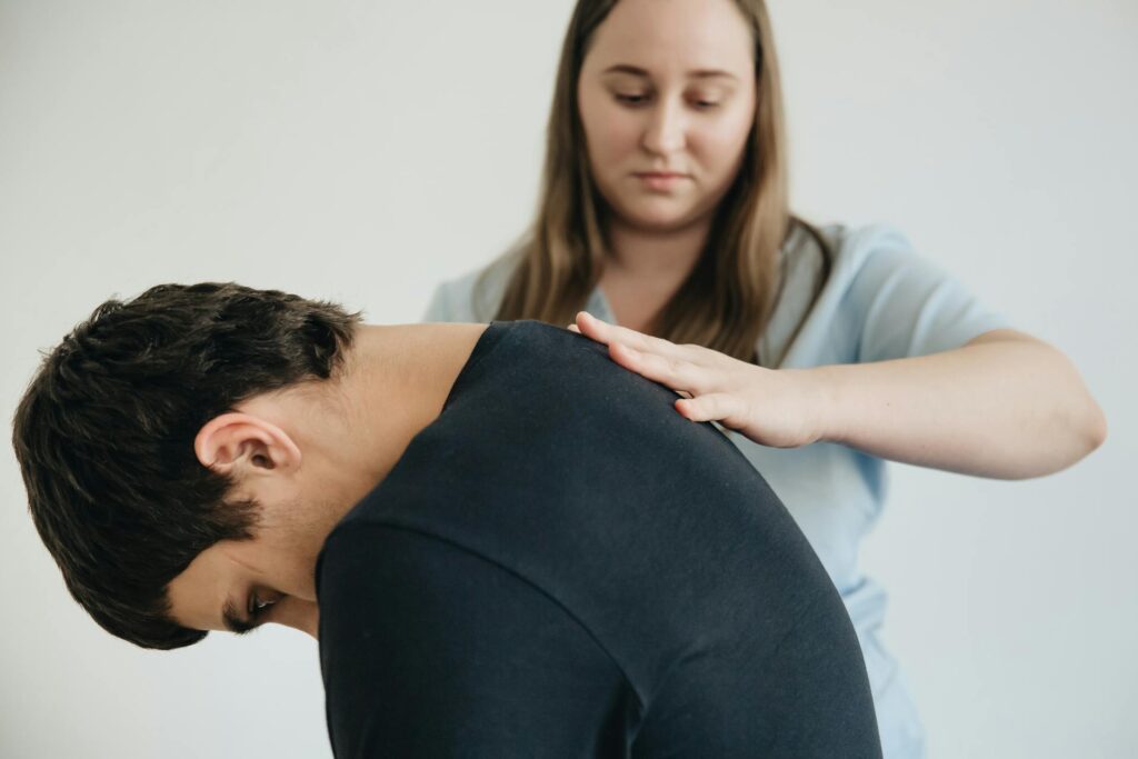 Physiotherapist in Vaughan performing manual therapy on a patient with lower back pain at PhysioChiroWellness