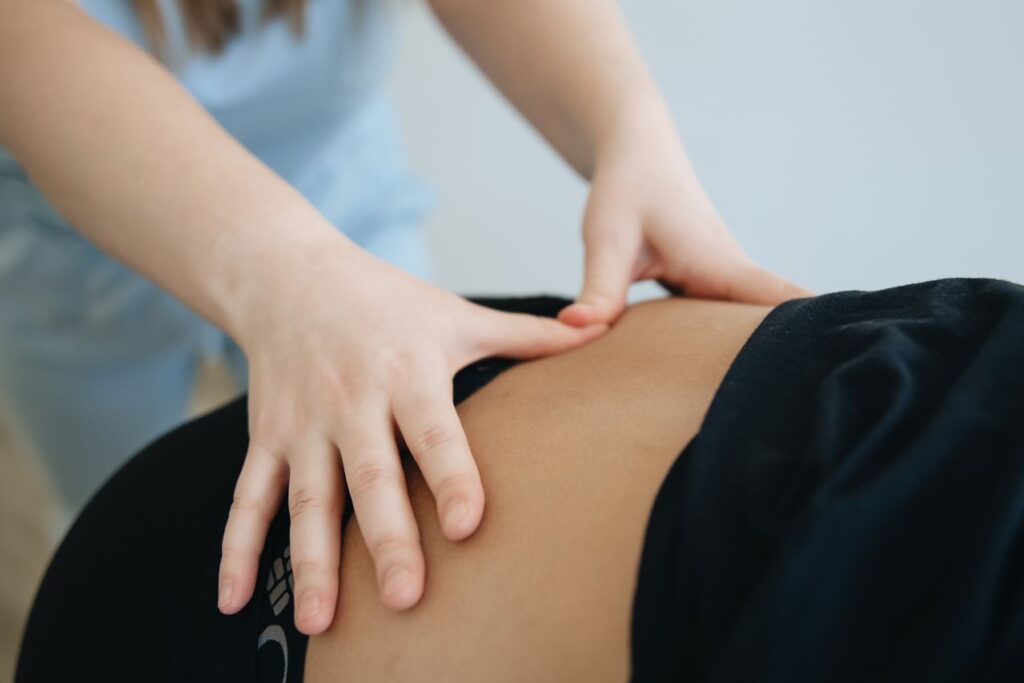 Chiropractor in Newmarket performing a spinal adjustment for lower back pain relief