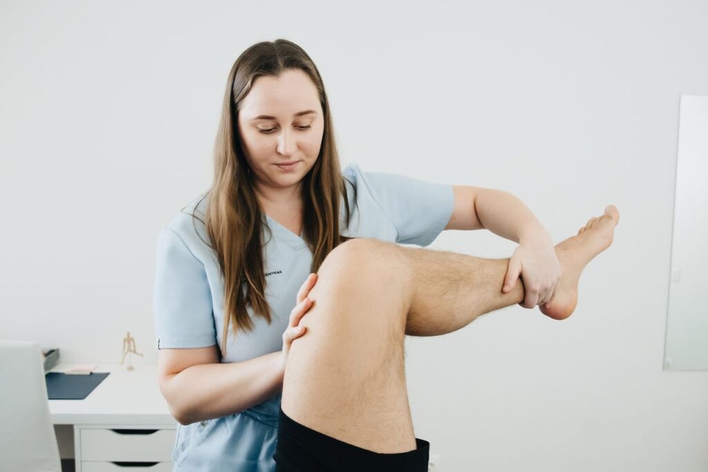 Physiotherapist in Newmarket treating a patient's knee injury during a WSIB-covered rehabilitation session