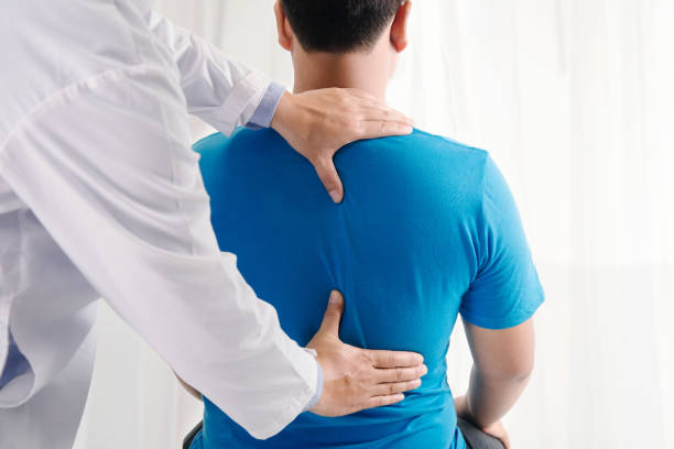Chiropractor in Vaughan examining a patient's spine during an initial consultation